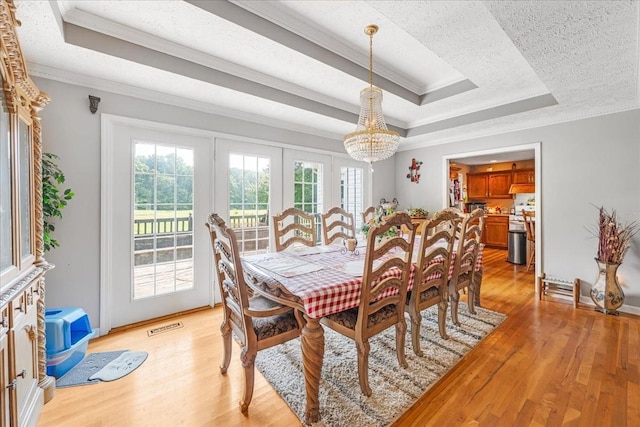 431 Jack Thomas Dr, Manchester, TN 37355 - dining room featuring ornamental molding, a tray ceiling, light wood-style flooring, a chandelier, and french doors
