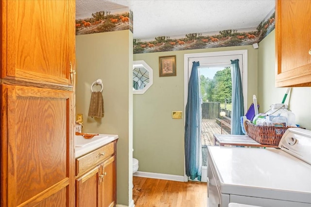 431 Jack Thomas Dr, Manchester, TN 37355 - washroom with washing machine and clothes dryer, light wood-type flooring, and baseboards