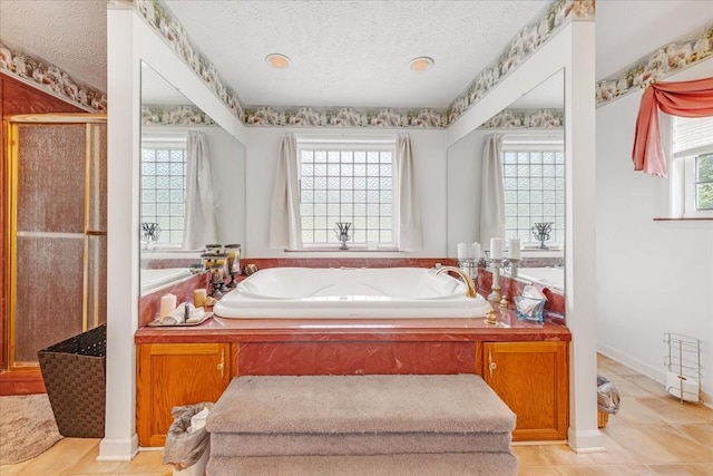 431 Jack Thomas Dr, Manchester, TN 37355 - full bath featuring a textured ceiling, a bath, a stall shower, and tile patterned flooring