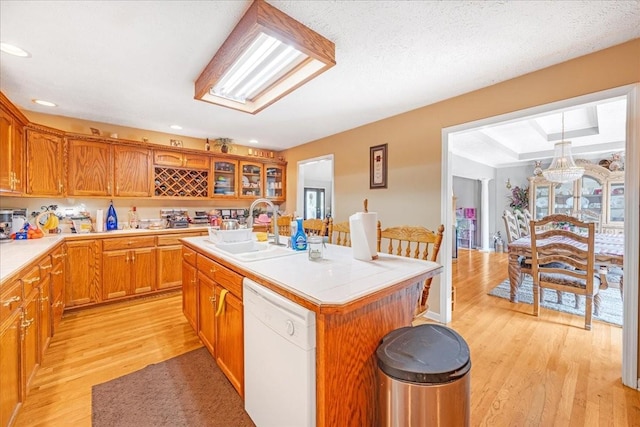 431 Jack Thomas Dr, Manchester, TN 37355 - kitchen with dishwasher, a sink, light wood-type flooring, a kitchen island with sink, and glass insert cabinets
