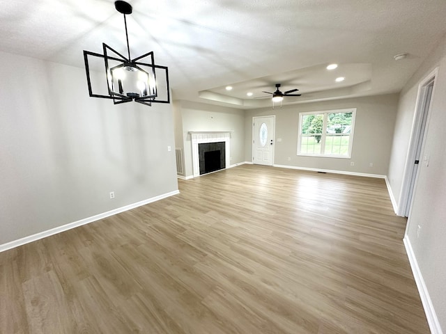 115 Briley Ln, Portland, TN 37148 - unfurnished living room featuring a raised ceiling, wood finished floors, ceiling fan, baseboards, and recessed lighting