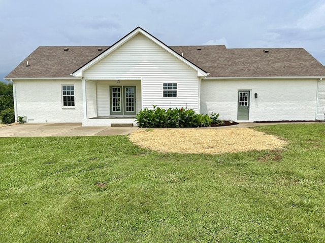 115 Briley Ln, Portland, TN 37148 - rear view of house with brick siding, a patio, roof with shingles, and a lawn