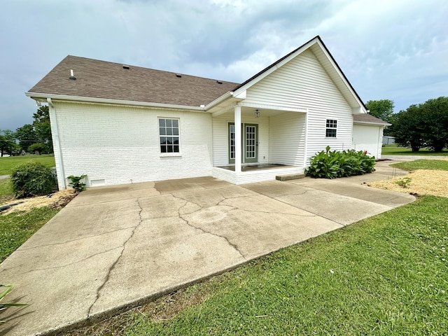 115 Briley Ln, Portland, TN 37148 - back of property with brick siding, a shingled roof, a patio area, and a yard