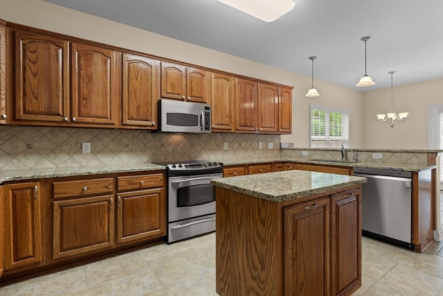 226 Wrennewood Ln, Franklin, TN 37064 - kitchen featuring stainless steel appliances, a sink, a peninsula, a kitchen island, and brown cabinetry
