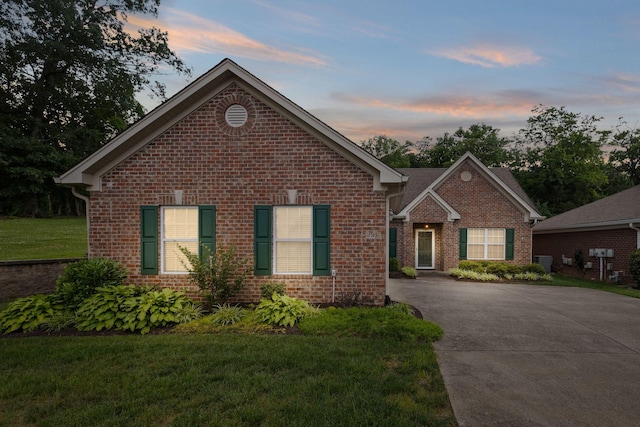 226 Wrennewood Ln, Franklin, TN 37064 - view of front of house with brick siding, a front lawn, central AC, and driveway