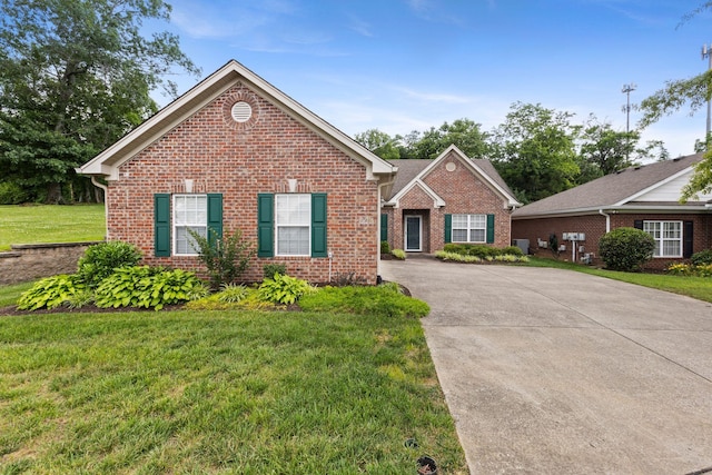 226 Wrennewood Ln, Franklin, TN 37064 - view of front of property featuring brick siding, a front lawn, and concrete driveway