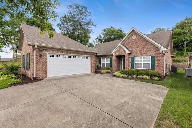 226 Wrennewood Ln, Franklin, TN 37064 - ranch-style home with brick siding, concrete driveway, an attached garage, central AC unit, and a shingled roof