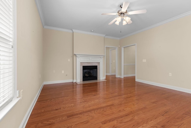 226 Wrennewood Ln, Franklin, TN 37064 - unfurnished living room featuring a ceiling fan, crown molding, light wood-type flooring, a premium fireplace, and baseboards
