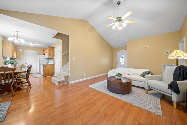 3700 Wheatfield Ln, Clarksville, TN 37040 - living area featuring vaulted ceiling, a ceiling fan, light wood-style flooring, stairs, and a chandelier
