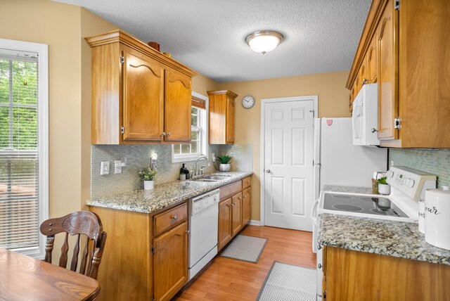 3700 Wheatfield Ln, Clarksville, TN 37040 - kitchen with white appliances, a sink, backsplash, light wood-type flooring, and a textured ceiling