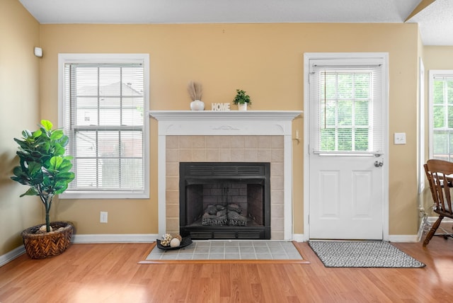 3700 Wheatfield Ln, Clarksville, TN 37040 - living area featuring wood finished floors, baseboards, and a tile fireplace