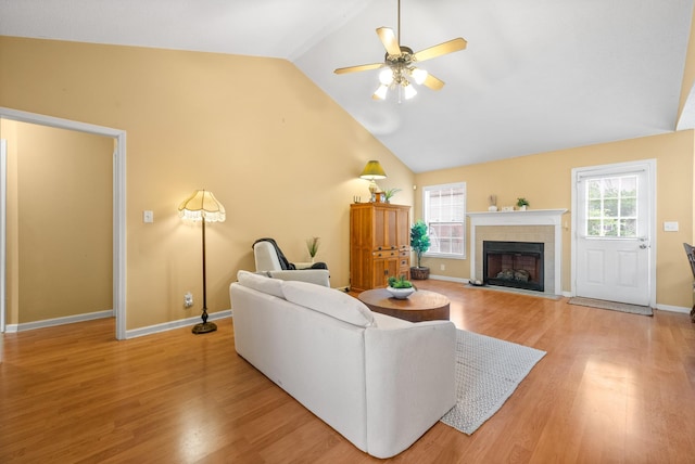 3700 Wheatfield Ln, Clarksville, TN 37040 - living room featuring ceiling fan, lofted ceiling, light wood-style floors, a fireplace, and baseboards