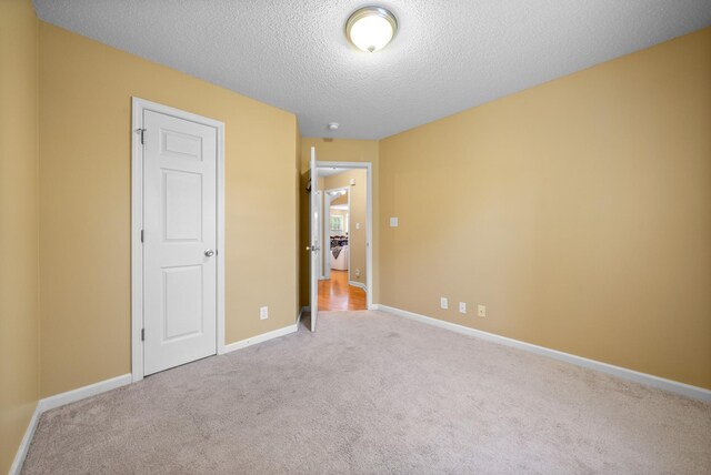 3700 Wheatfield Ln, Clarksville, TN 37040 - unfurnished bedroom featuring carpet floors, a textured ceiling, and baseboards