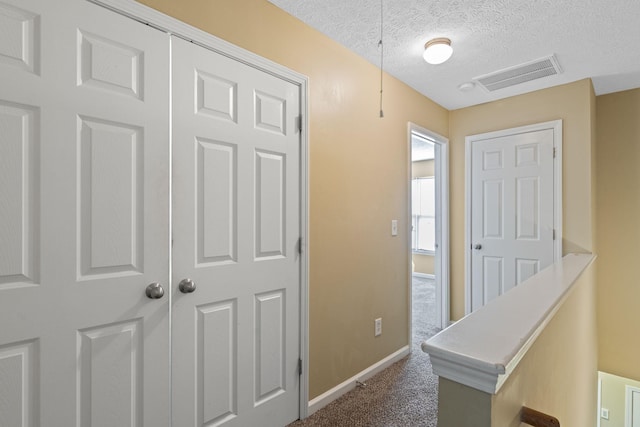 1515 Bridgecrest Dr Unit 220, Antioch, TN 37013 - corridor featuring a textured ceiling, baseboards, and carpet floors