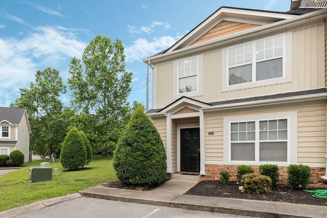 1515 Bridgecrest Dr Unit 220, Antioch, TN 37013 - view of front facade featuring a front yard, board and batten siding, and stone siding