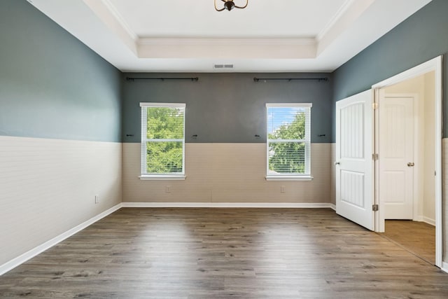 3211 Briar Chapel Dr, Murfreesboro, TN 37128 - empty room featuring a raised ceiling, crown molding, a wainscoted wall, wood finished floors, and baseboards