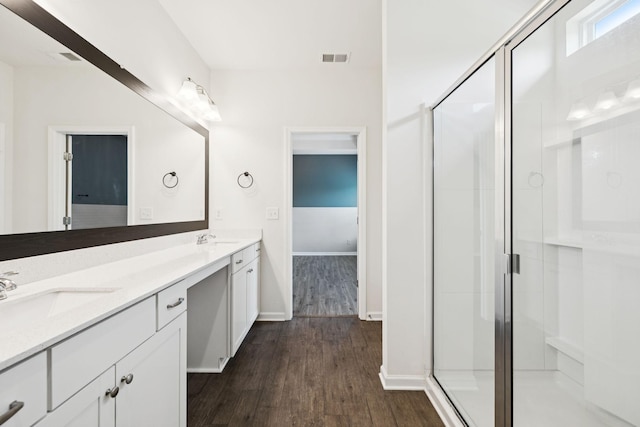 3211 Briar Chapel Dr, Murfreesboro, TN 37128 - full bathroom featuring wood finished floors, double vanity, a shower stall, and baseboards