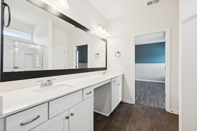 3211 Briar Chapel Dr, Murfreesboro, TN 37128 - bathroom with wood finished floors, double vanity, a stall shower, and baseboards