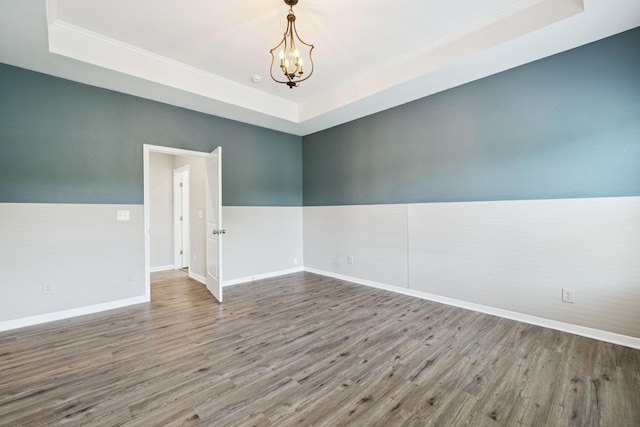 3211 Briar Chapel Dr, Murfreesboro, TN 37128 - spare room featuring a raised ceiling, wood finished floors, a chandelier, crown molding, and baseboards