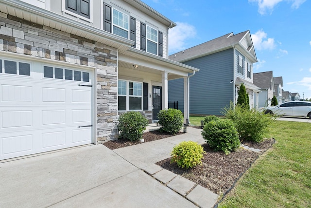 3211 Briar Chapel Dr, Murfreesboro, TN 37128 - view of front facade with covered porch, stone siding, a front yard, and an attached garage