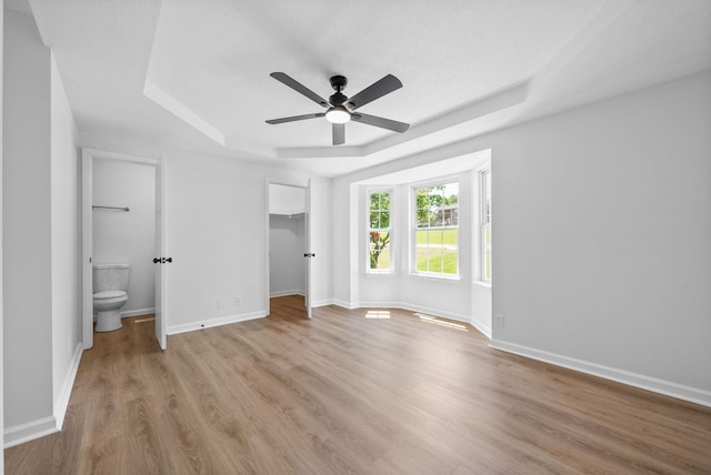 171 Stephanie Dr, Clarksville, TN 37042 - unfurnished bedroom with a raised ceiling, wood finished floors, baseboards, a spacious closet, and ensuite bath