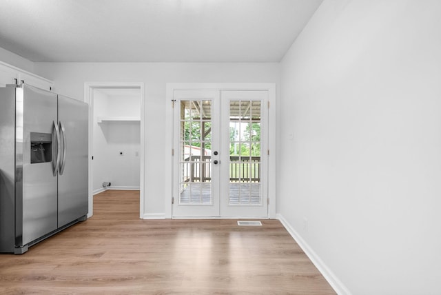 171 Stephanie Dr, Clarksville, TN 37042 - unfurnished dining area featuring french doors, baseboards, and light wood-style floors