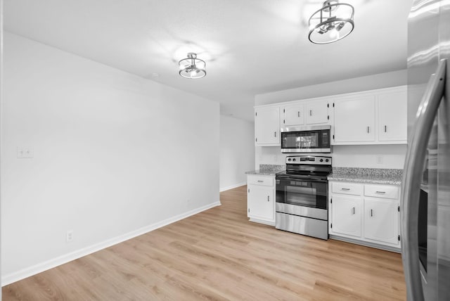 171 Stephanie Dr, Clarksville, TN 37042 - kitchen featuring appliances with stainless steel finishes, white cabinetry, light wood-style flooring, and baseboards