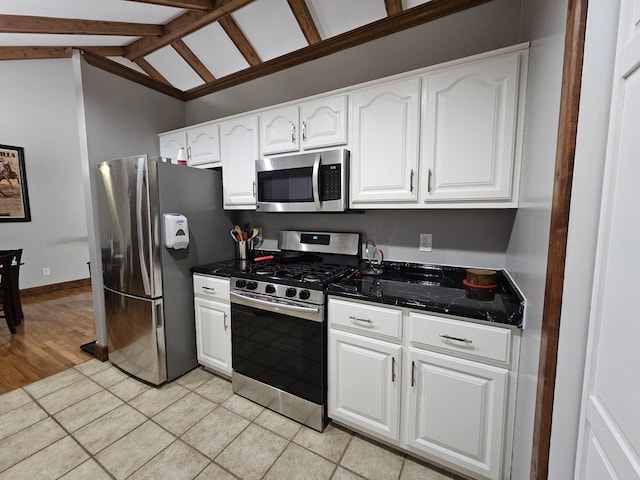 2524 Distillery Rd, Greenbrier, TN 37073 - kitchen with appliances with stainless steel finishes, white cabinetry, lofted ceiling, and light tile patterned floors
