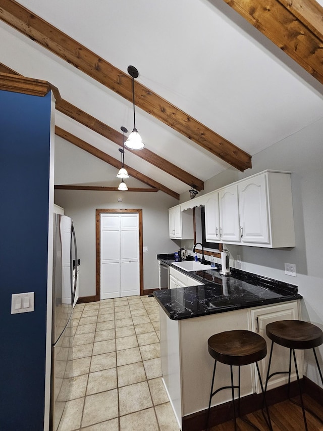 2524 Distillery Rd, Greenbrier, TN 37073 - kitchen with a sink, a peninsula, white cabinetry, freestanding refrigerator, and pendant lighting
