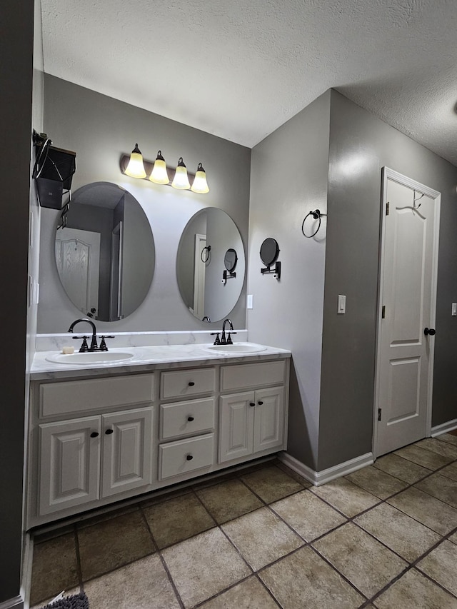 2524 Distillery Rd, Greenbrier, TN 37073 - full bathroom with double vanity, a textured ceiling, and baseboards
