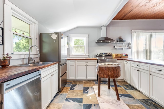 1812 Elizabeth Rd, Nashville, TN 37218 - kitchen with appliances with stainless steel finishes, butcher block counters, wall chimney exhaust hood, vaulted ceiling, and a sink