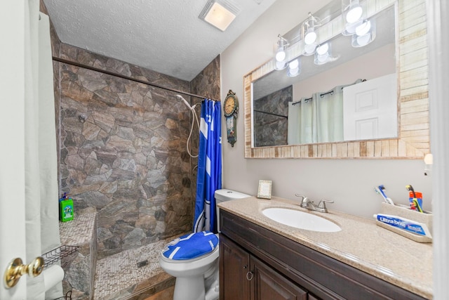 314 Millhouse Rd, Smyrna, TN 37167 - bathroom featuring toilet, a tile shower, vanity, and a textured ceiling