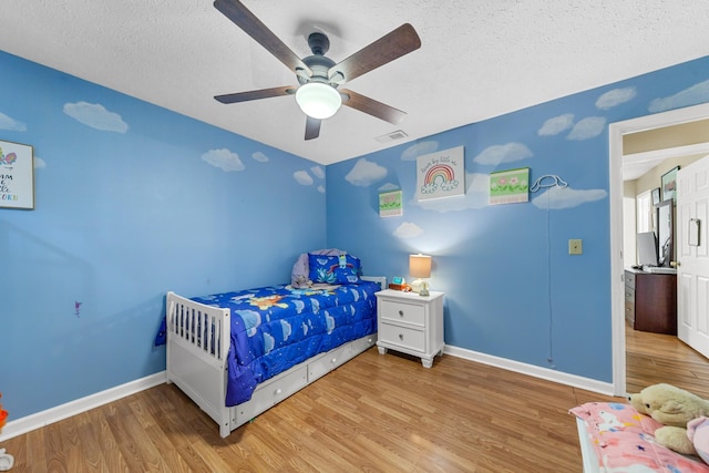 314 Millhouse Rd, Smyrna, TN 37167 - bedroom featuring wood finished floors, baseboards, a textured ceiling, and a ceiling fan