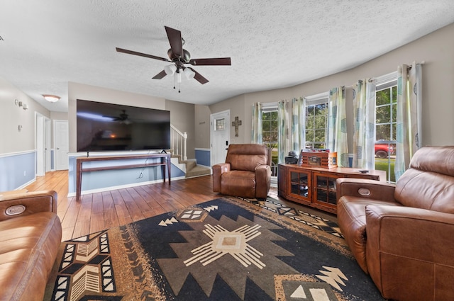 314 Millhouse Rd, Smyrna, TN 37167 - living room with stairway, hardwood / wood-style flooring, a textured ceiling, a ceiling fan, and baseboards