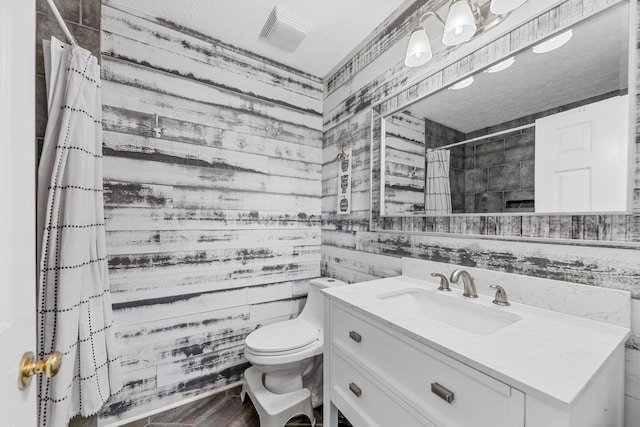 314 Millhouse Rd, Smyrna, TN 37167 - bathroom with vanity, toilet, a tile shower, wood walls, and wood finished floors