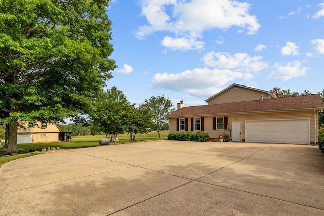 346 Spring Creek Ln, Lebanon, TN 37090 - ranch-style home with concrete driveway, an attached garage, and a chimney