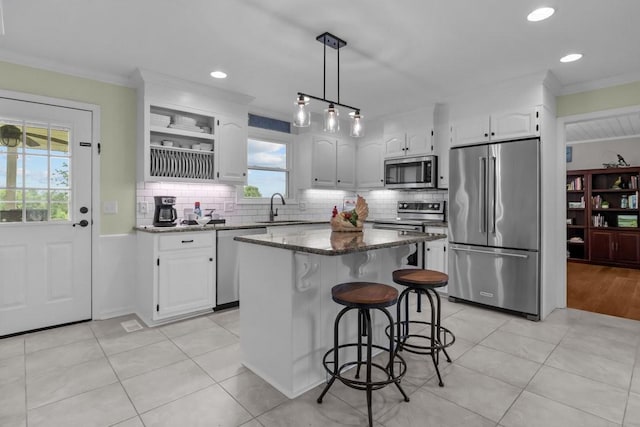 346 Spring Creek Ln, Lebanon, TN 37090 - kitchen featuring stainless steel appliances, a sink, dark stone countertops, white cabinets, and a kitchen island