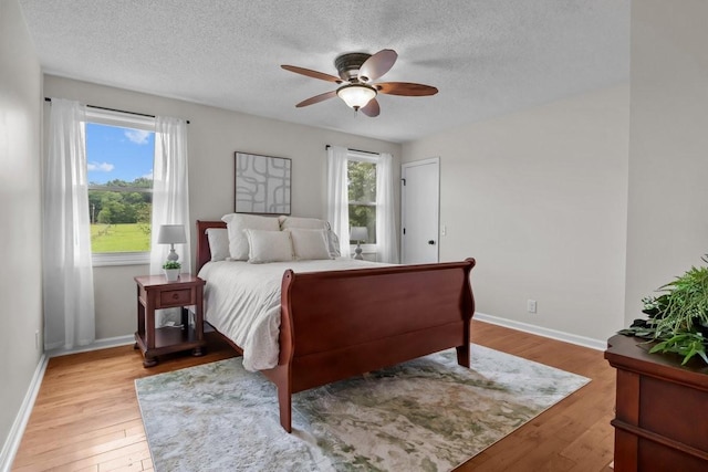 346 Spring Creek Ln, Lebanon, TN 37090 - bedroom featuring light wood-style floors, a textured ceiling, baseboards, and ceiling fan