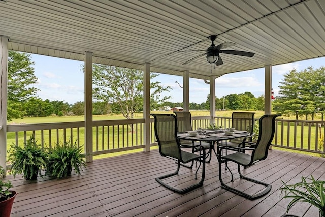 346 Spring Creek Ln, Lebanon, TN 37090 - wooden deck with outdoor dining area, ceiling fan, view of wooded area, and a lawn