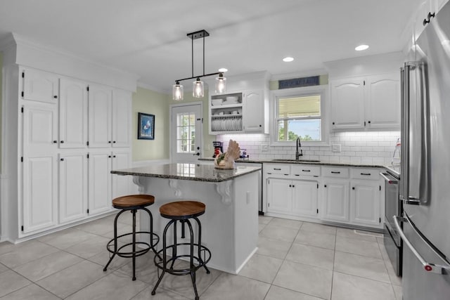 346 Spring Creek Ln, Lebanon, TN 37090 - kitchen with appliances with stainless steel finishes, a sink, a kitchen breakfast bar, a center island, and dark stone countertops