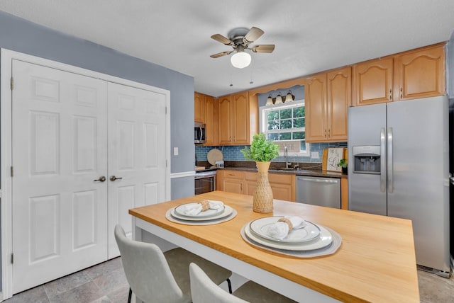 1921 Timberline Cir, Oak Grove, KY 42262 - kitchen with stainless steel appliances, a ceiling fan, decorative backsplash, a sink, and light stone finish flooring