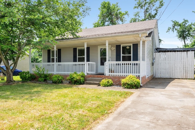 1921 Timberline Cir, Oak Grove, KY 42262 - view of front of house featuring a porch, a front lawn, and concrete driveway