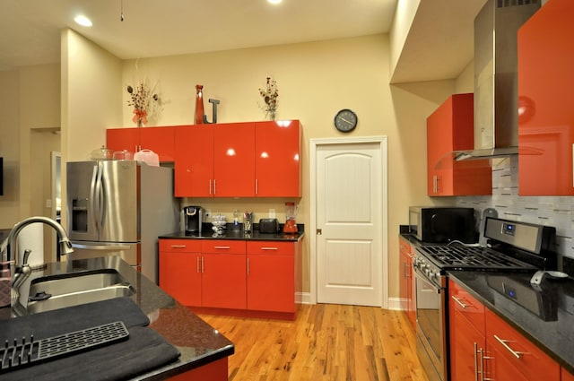 3173 Porter Hills Dr, Clarksville, TN 37043 - kitchen featuring red cabinets, appliances with stainless steel finishes, a sink, light wood-type flooring, and backsplash