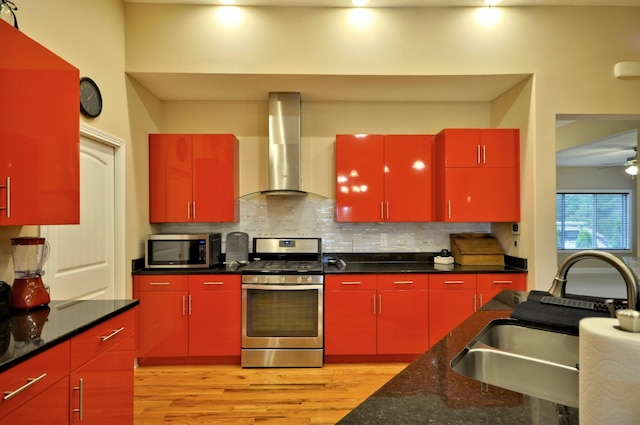 3173 Porter Hills Dr, Clarksville, TN 37043 - kitchen featuring red cabinetry, appliances with stainless steel finishes, wall chimney range hood, and a sink