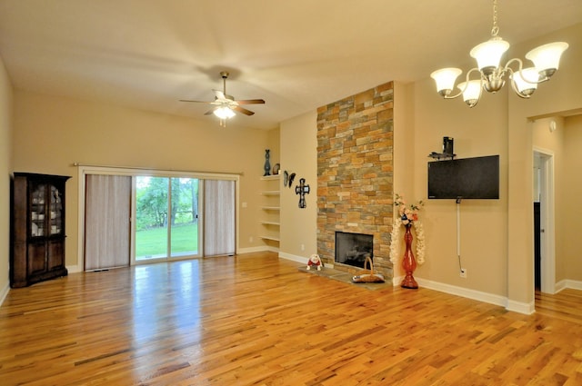 3173 Porter Hills Dr, Clarksville, TN 37043 - unfurnished living room with light wood-style flooring, a chandelier, a ceiling fan, a stone fireplace, and baseboards