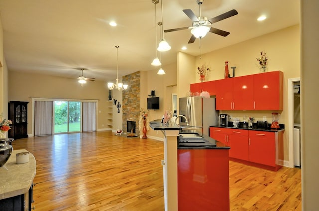 3173 Porter Hills Dr, Clarksville, TN 37043 - kitchen featuring red cabinetry, stainless steel refrigerator with ice dispenser, a ceiling fan, a fireplace, and recessed lighting