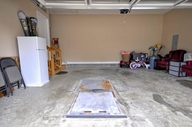 3173 Porter Hills Dr, Clarksville, TN 37043 - garage featuring freestanding refrigerator, a garage door opener, and electric panel