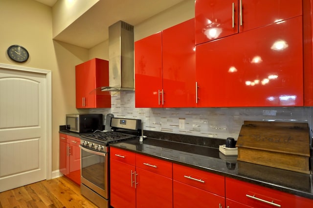 3173 Porter Hills Dr, Clarksville, TN 37043 - kitchen with red cabinets, stainless steel appliances, and decorative backsplash
