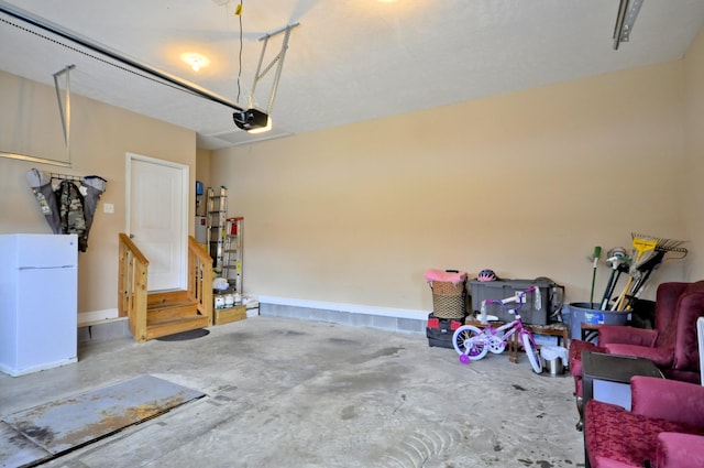 3173 Porter Hills Dr, Clarksville, TN 37043 - garage with a garage door opener and freestanding refrigerator