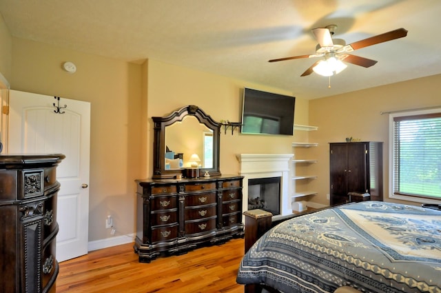 3173 Porter Hills Dr, Clarksville, TN 37043 - bedroom featuring wood finished floors, a fireplace, baseboards, and a ceiling fan